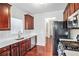 Traditional kitchen with stainless steel appliances, white countertops and dark wood cabinets and floors at 915 Pebble Creek Trl, Suwanee, GA 30024