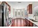 Bright breakfast nook off kitchen with wood floors, stainless steel appliances, and ample light at 915 Pebble Creek Trl, Suwanee, GA 30024