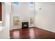 Inviting living room with tall ceilings, dark hardwood floors and a fireplace with a dark mantel at 915 Pebble Creek Trl, Suwanee, GA 30024