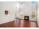Bright and open living room featuring hardwood floors, a fireplace, and large windows with plenty of natural light at 915 Pebble Creek Trl, Suwanee, GA 30024