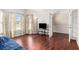 Cozy living room showcasing hardwood floors, large windows, and French doors leading to another room at 915 Pebble Creek Trl, Suwanee, GA 30024