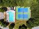 Overhead view of pool and tennis courts in community with mature trees at 1492 Station Ridge Ct, Lawrenceville, GA 30045
