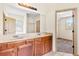 Well-lit bathroom featuring granite counters, double sinks, tile flooring and bedroom access at 1492 Station Ridge Ct, Lawrenceville, GA 30045