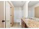 Bathroom features a granite countertop vanity, tub with shower, and neutral tile floors at 1492 Station Ridge Ct, Lawrenceville, GA 30045