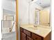 Bathroom vanity featuring a large mirror, white countertop, and dark wooden cabinets at 1492 Station Ridge Ct, Lawrenceville, GA 30045