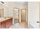 Bright bathroom showcasing tile floor, granite counters, vanity, and access to the bedroom at 1492 Station Ridge Ct, Lawrenceville, GA 30045