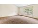 Comfortable bedroom with soft carpet, natural light and neutral-colored trim at 1492 Station Ridge Ct, Lawrenceville, GA 30045