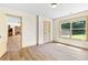 Bedroom features wood-look floors and a view into the kitchen and backyard at 1492 Station Ridge Ct, Lawrenceville, GA 30045