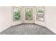 Bedroom featuring three bay windows and carpeted floors at 1492 Station Ridge Ct, Lawrenceville, GA 30045