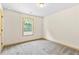 Bedroom featuring neutral carpet, a ceiling fan, and a window letting in natural light at 1492 Station Ridge Ct, Lawrenceville, GA 30045