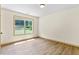 Bedroom with wood-look floors and a large window providing natural light and backyard view at 1492 Station Ridge Ct, Lawrenceville, GA 30045