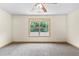 Bright bedroom featuring neutral carpet, a ceiling fan, and a window letting in natural light at 1492 Station Ridge Ct, Lawrenceville, GA 30045