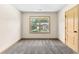A spacious bedroom with neutral walls, a window view, and soft carpet for comfort at 1492 Station Ridge Ct, Lawrenceville, GA 30045