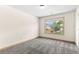 Bright bedroom featuring soft carpet, ample natural light, and view of a fenced backyard at 1492 Station Ridge Ct, Lawrenceville, GA 30045