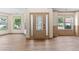 Spacious entryway featuring luxury vinyl plank flooring, large windows and a Craftsman style front door at 1492 Station Ridge Ct, Lawrenceville, GA 30045