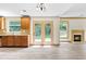 Kitchen and living area featuring backyard access via glass patio doors and fireplace at 1492 Station Ridge Ct, Lawrenceville, GA 30045