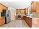 Kitchen featuring stainless steel appliances, granite counters, and wood-look flooring at 1492 Station Ridge Ct, Lawrenceville, GA 30045