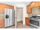 This kitchen features stainless steel appliances and pantry space with wooden cabinetry at 1492 Station Ridge Ct, Lawrenceville, GA 30045