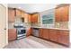 Well-lit kitchen featuring wood cabinets, granite countertops, stainless steel appliances and modern backsplash at 1492 Station Ridge Ct, Lawrenceville, GA 30045