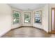 This light filled living room features luxury vinyl plank flooring and large windows offering views of the yard at 1492 Station Ridge Ct, Lawrenceville, GA 30045