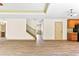 Living Room showing stairs, bathroom, and a view through to the front entryway at 1492 Station Ridge Ct, Lawrenceville, GA 30045