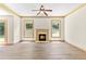 Living room featuring a fireplace, wood-look floors, and a ceiling fan at 1492 Station Ridge Ct, Lawrenceville, GA 30045