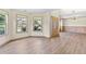 This light filled living room features luxury vinyl plank flooring, an entry door and large windows at 1492 Station Ridge Ct, Lawrenceville, GA 30045