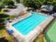 Aerial shot of a community swimming pool with lounge chairs and umbrellas in a fenced area at 1492 Station Ridge Ct, Lawrenceville, GA 30045