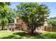 The home and backyard, featuring a deck area and mature shade trees at 2102 Berryhill Se Cir, Smyrna, GA 30082
