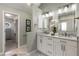 Bright bathroom featuring double sink vanity, white cabinets, and tiled floors at 2102 Berryhill Se Cir, Smyrna, GA 30082