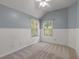 Bedroom featuring two windows, wainscoting, a ceiling fan, and neutral carpeting at 2102 Berryhill Se Cir, Smyrna, GA 30082