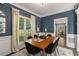 Stylish dining room featuring wainscoting, modern lighting, and ample natural light at 2102 Berryhill Se Cir, Smyrna, GA 30082