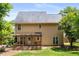The exterior of the home offers a wooden deck, lawn, and mature trees at 2102 Berryhill Se Cir, Smyrna, GA 30082
