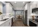 Bright kitchen with stainless appliances, white cabinetry, and open layout to dining area at 2102 Berryhill Se Cir, Smyrna, GA 30082