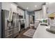 Updated kitchen featuring stainless appliances, white cabinets, and stylish herringbone tile backsplash at 2102 Berryhill Se Cir, Smyrna, GA 30082