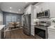Bright eat-in kitchen with white cabinetry, stainless steel appliances, and luxury vinyl plank flooring at 2102 Berryhill Se Cir, Smyrna, GA 30082