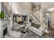 Inviting living room with fireplace, staircase, and seamless flow to dining area at 2102 Berryhill Se Cir, Smyrna, GA 30082