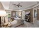 Beautifully decorated main bedroom with tray ceilings, neutral colors, and a ceiling fan at 2102 Berryhill Se Cir, Smyrna, GA 30082