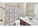 Charming bathroom with a seashell-themed shower curtain, a vanity with a marble countertop, and bronze fixtures at 2619 Dayview Ln, Atlanta, GA 30331