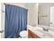 Bathroom featuring a toilet, vanity with sink, and a shower with a blue curtain at 2619 Dayview Ln, Atlanta, GA 30331
