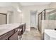 Bathroom with double vanity, marble countertops, and separate glass-enclosed shower at 2619 Dayview Ln, Atlanta, GA 30331