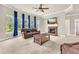 Comfortable living room with a stone fireplace, ceiling fan, and large windows at 2619 Dayview Ln, Atlanta, GA 30331