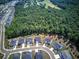 Aerial view showcasing a new residential development surrounded by lush greenery and community amenities at 841 Keystone Dr, Woodstock, GA 30188