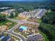 Enjoy an aerial view of this community featuring sidewalks, green space, a pool, and clubhouse surrounded by trees at 841 Keystone Dr, Woodstock, GA 30188