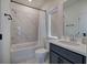 Clean bathroom featuring tub and shower combo with marble tile at 841 Keystone Dr, Woodstock, GA 30188