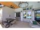 Inviting covered patio with spacious seating, wood ceiling, brick details, and access to community pool at 841 Keystone Dr, Woodstock, GA 30188