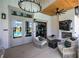 Stunning covered patio with wood ceiling, brick fireplace, modern lighting, and comfortable seating at 841 Keystone Dr, Woodstock, GA 30188