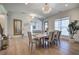 Bright dining room features hardwood floors, modern lighting, and a view into other living spaces at 841 Keystone Dr, Woodstock, GA 30188