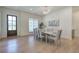 Stylish dining area offers natural light, modern chandelier, and seating for six at 841 Keystone Dr, Woodstock, GA 30188