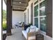 Comfortable front porch seating with stylish decor and exterior window details at 841 Keystone Dr, Woodstock, GA 30188